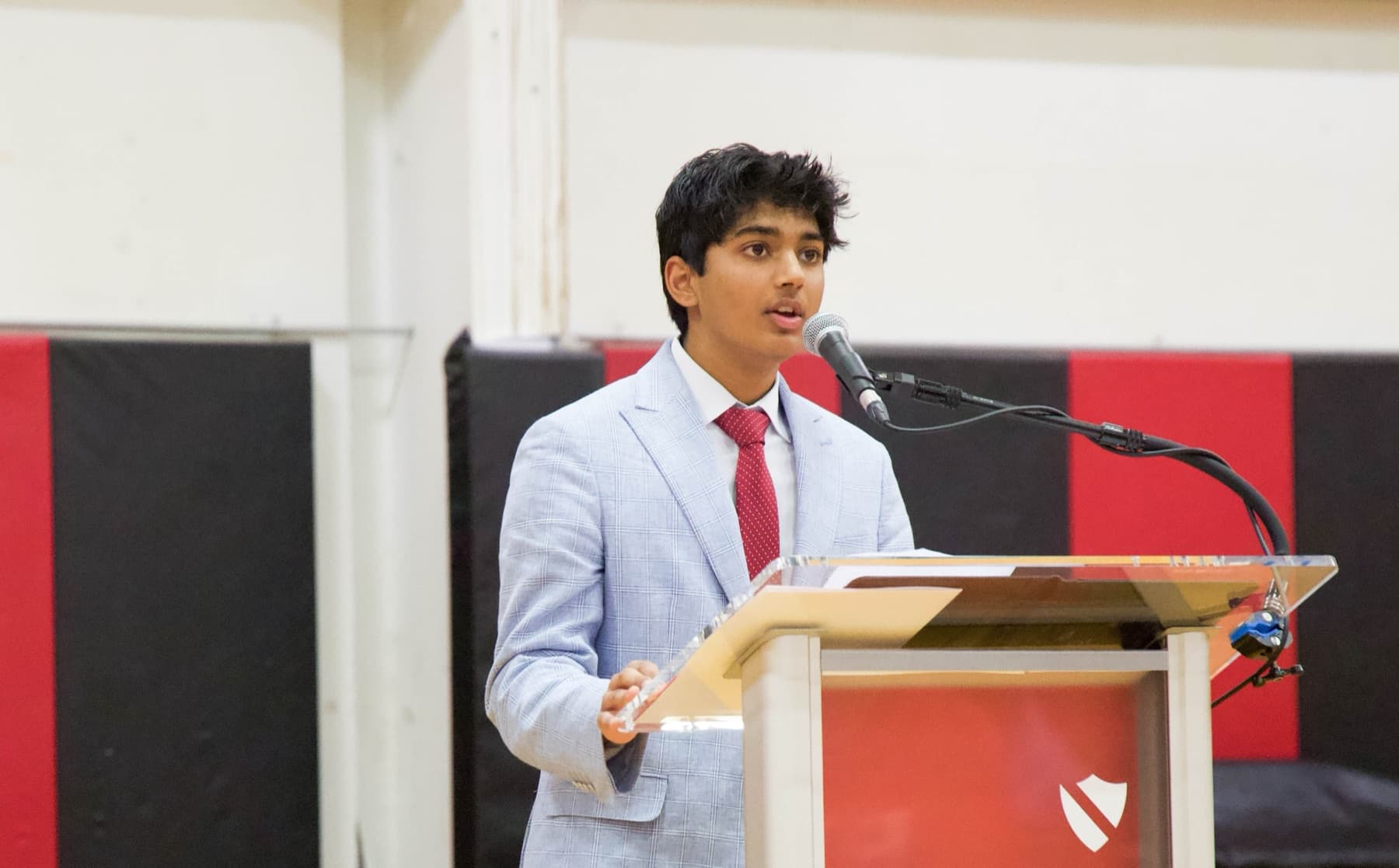 Arsh speaking at a podium as Student Body President