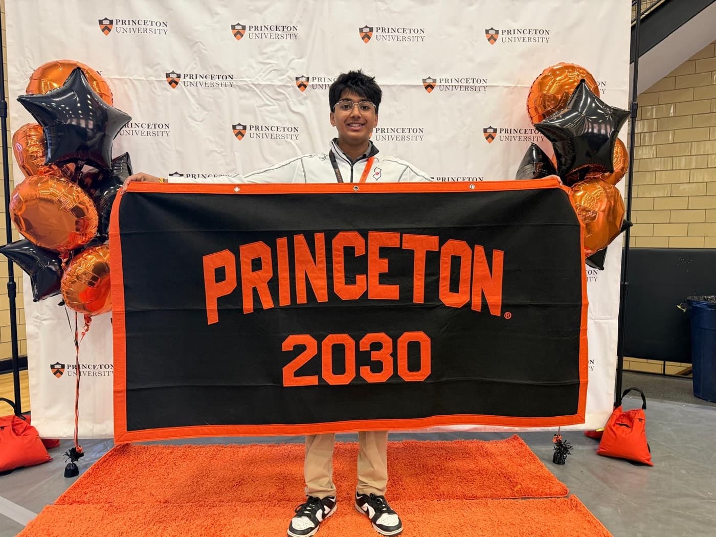 Arsh holding the Princeton 2030 banner on Preview day